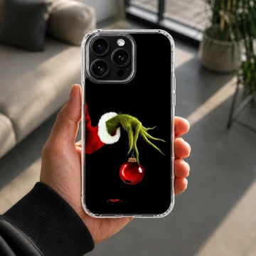Grinch holding ornament in holiday-themed phone case — Lifestyle