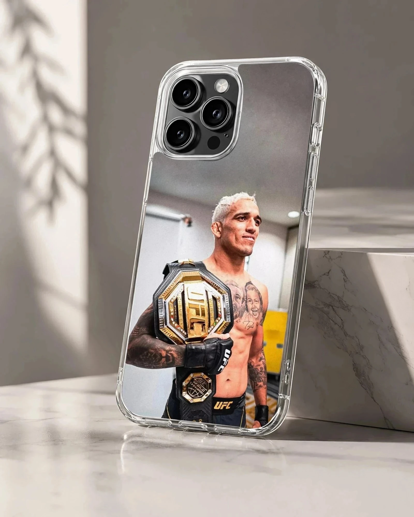 Charles Oliveira holding a gold championship belt printed on a matte phone case