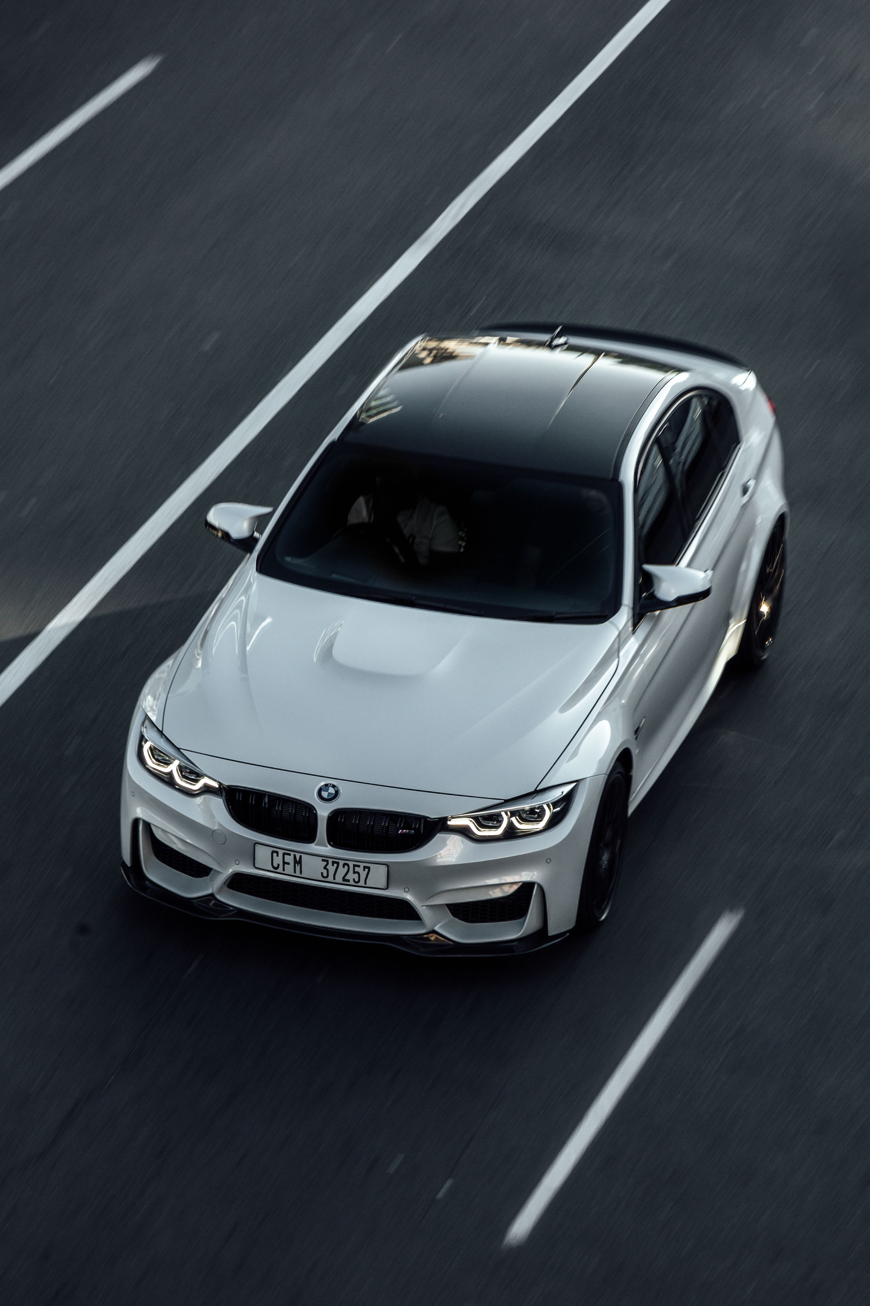 Sharp original photo of a white BMW M4 on the road, used as the source image for a custom phone case